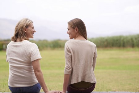 Mother and daughter sitting and together